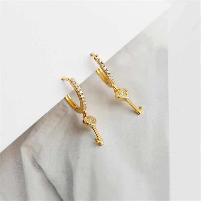 Orecchini a cerchio Key of Love in oro